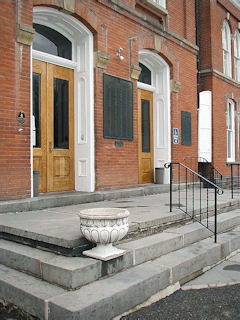 Pike County Courthouse steps. The benchmark is located just to the right of the can in front of the near door.