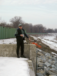 Rich points to the disk, right on the corner of the little concrete wall.