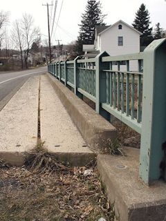 The marker on the concrete bridge. Looking south-southwest.