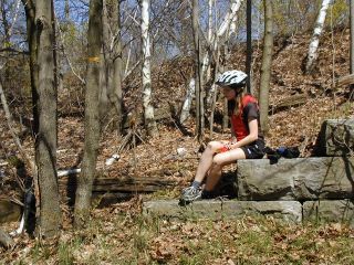 Zhanna looks down at the chiseled mark on the abutment.