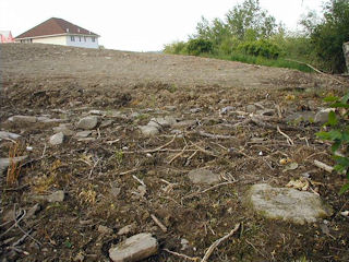 Looking northeast: plenty of rocks and rubble, and a reference mark.