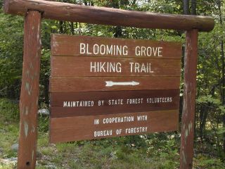 Sign at entrance of trail road and parking area.