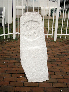 The south side of the stone bears the coat of arms of the Calverts.