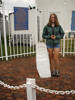 Zhanna stands by the monument on a rainy Sunday morning.