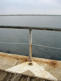 Looking southwest across the inlet toward the seawall at the northernmost edge of Assateague Island.