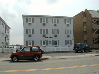 The Six West Apartments (#425), with the red vehicle in front of the mark.