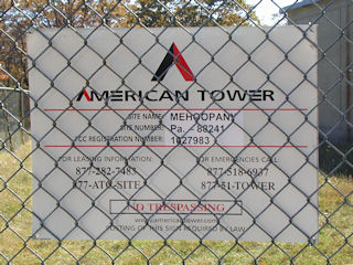 “American Tower” sign on the perimeter fence.