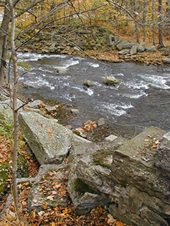 View facing remains of southeast abutment, drill hole indicated.