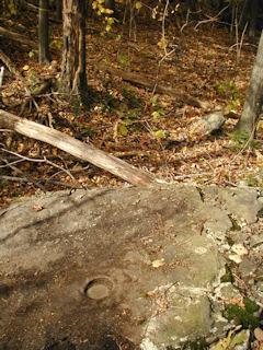 Eye-level view of the station mark on the boulder.