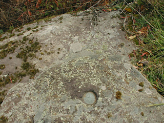 Eye-level view of the mark on the outcropping.