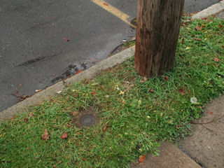 Eyelevel view of the azimuth mark between the curb and sidewalk.