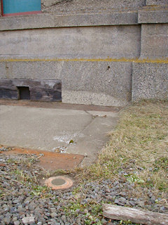 Eye-level view of the mark, with the north wall of the control tower in the background.