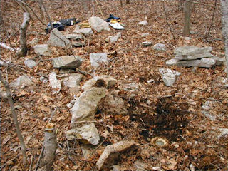 The mark surrounded by rocks and our tools.