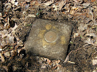 Eye-level view of mark on monument, showing nails that point to the RMs.