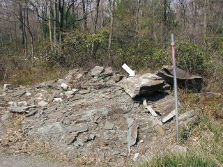 The mark is perched on top of the pile of rubble.