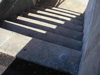 An eye-level view of the disk on the top concrete step.