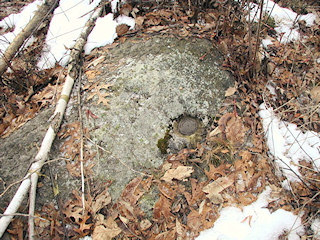 Eye-level view of the station mark set in a rock outcrop.