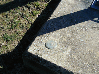 Eyelevel view of the disk set into the concrete base.