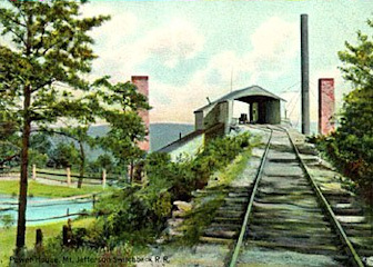 Engine house, smokestack and chimneys. The pond nearby served as a reservoir for the steam engine boilers.