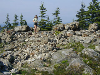 Zhanna climbs around on the rubble.