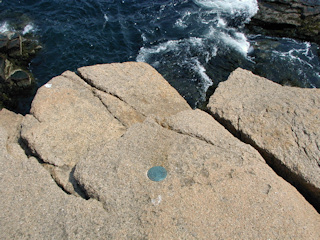 HOLE is a nice example of a topographic station disk high on an outcrop above the sea …