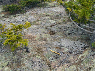 Eyelevel view of bolt (indicated at pencil-tip). It blends in very well with the surrounding bedrock.