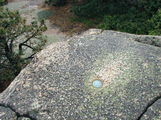 Eyelevel view of RM 2 disk set into rock ledge.