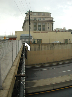 Looking west across the bridge toward the old Lackawanna Railroad Station (now a hotel) and the mark (indicated).