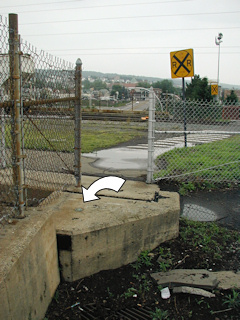 Looking south toward the tracks and pedestrian crossing. The sky just begins to clear after an evening rain shower.