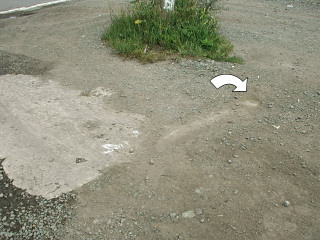 Eyelevel view of the mark on the concrete base.