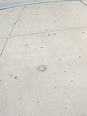 Eyelevel view of the disk in the sidewalk