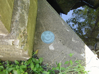 This disk can be found in the northwest wingwall of this bridge over Hettesheimer Run.