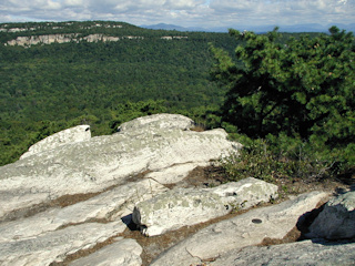 View to the NE, overlooking the white cliffs of the Shawangunk Ridge. The higher peaks of the Catskills are visible in the distance.