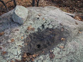 Eyelevel view of the drill hole (missing disk) on the rock outcrop.