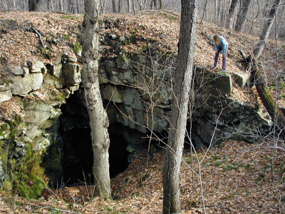 Zhanna peeks into one of the two deep shafts of the Winston Mine complex.