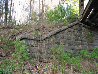 The mark is set vertically into the stone abutment.