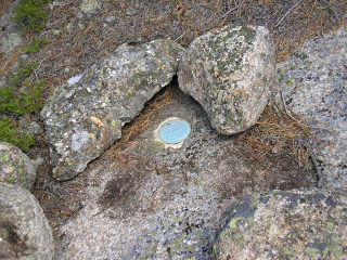 Eyelevel view of disk, also partially ringed by small rocks.