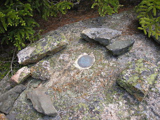 Eyelevel view of disk, also partially ringed by small rocks.