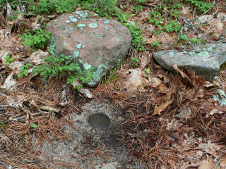 Eyelevel view of the station disk on bedrock.