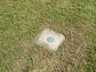 Eyelevel view of the monument in the nicely-mowed grass.