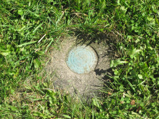 Eyelevel view of monument, flush with the ground.