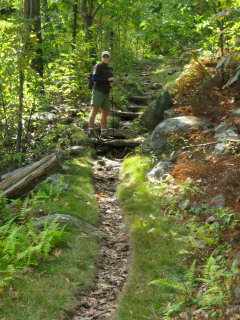 Rich begins to climb some steps on the trail.