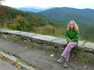 Getting ready for the long hike ahead of us on this chilly morning, Zhanna rests on the wall at Tunnel Parking Overlook.