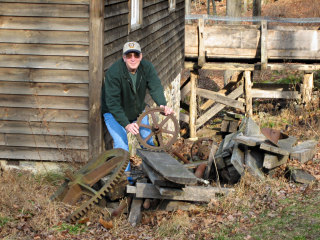 Rich plays around among some massive gears and other scraps near the old mill.