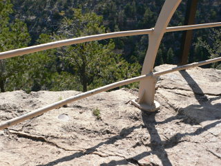 Peering through the railing, we could just barely make out the cliff dwellings.