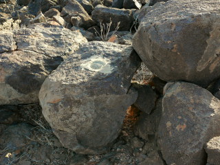 Eyelevel view of the reference mark disk set into a basalt boulder.