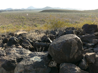 Looking W toward the azimuth mark, the road, and mountains in the background.