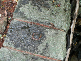 Eyelevel view of chiseled square in stonework dam.