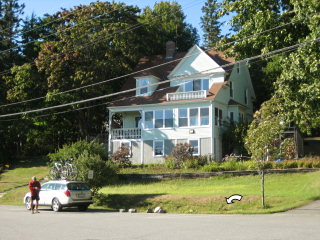 The outcrop is in the corner of this yard in front of the house at the intersection of Clark Point Rd. and Claremont Rd. View NNW.