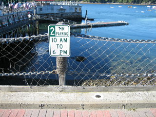 Eyelevel view of the disk set into the concrete berm near the water's edge.